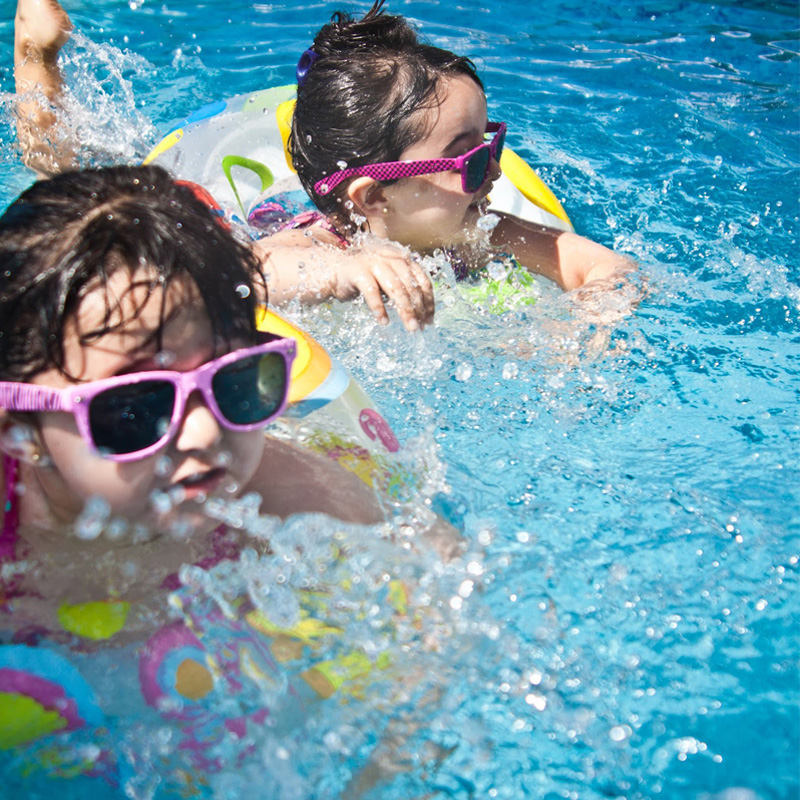 children in pool with floaties